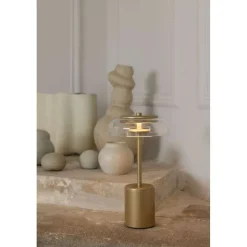 Nuura LED-batteridrevet bordlampe Blossi, højde 26 cm, guldfarvet/klar